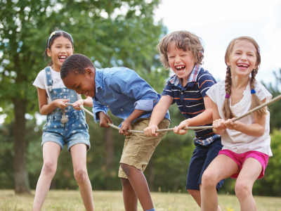 55606029_m kids pulling rope children playing tug of war, all smiling